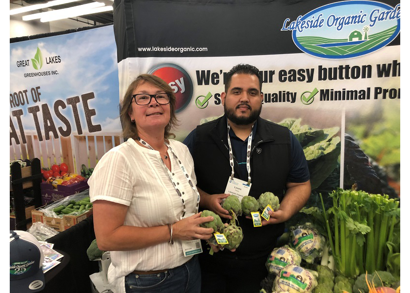 Marliese Myers, marketing director for Lakeside Organic Gardens, Watsonville, Calif., and Louis  Perez, sales executive, show the company’s branded artichokes at the July 28-29 IFPA Foodservice Conference. 