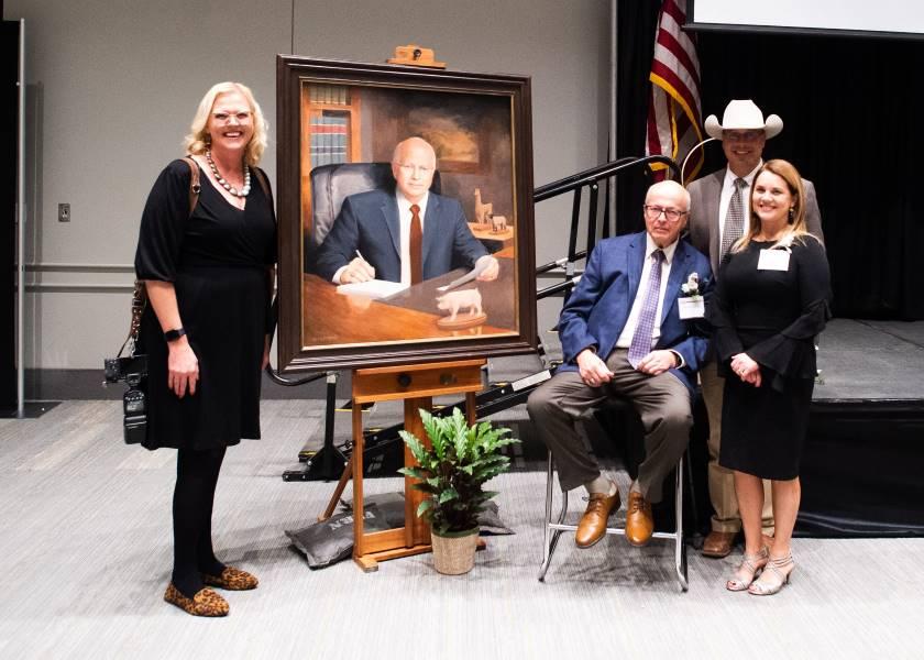 Because of Darrell Anderson's leadership, his employees had the opportunity to spread their wings and soar in their careers. Darrell poses with his portrait that will be hung in the Saddle and Sirloin Club Portrait Gallery in Louisville and former employees (l to r) Christy Lee, Kade Hummel and Jennifer Shike.