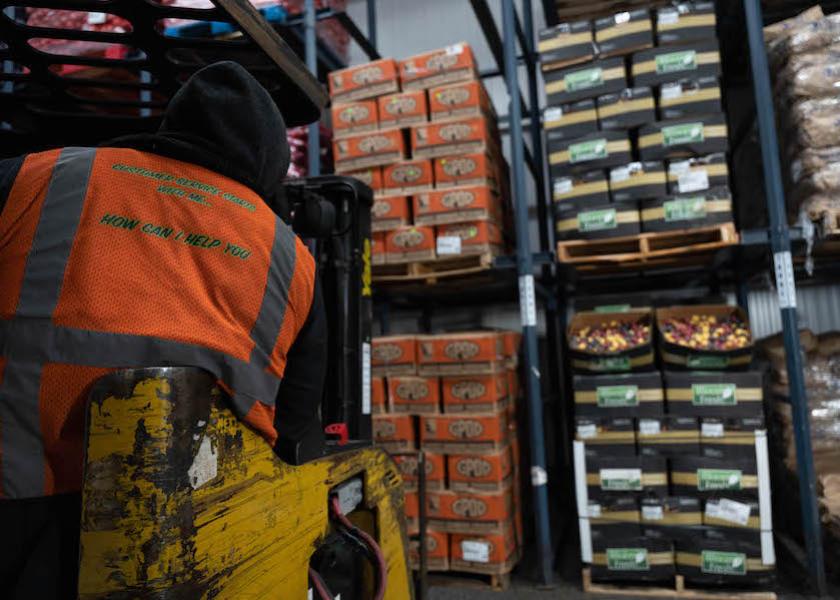 A S. Katzman Produce hi-lo truck driver lifts some vegetables inside the refrigerated warehouse to fill orders at Hunts Point Produce Market in Bronx, N.Y. 
