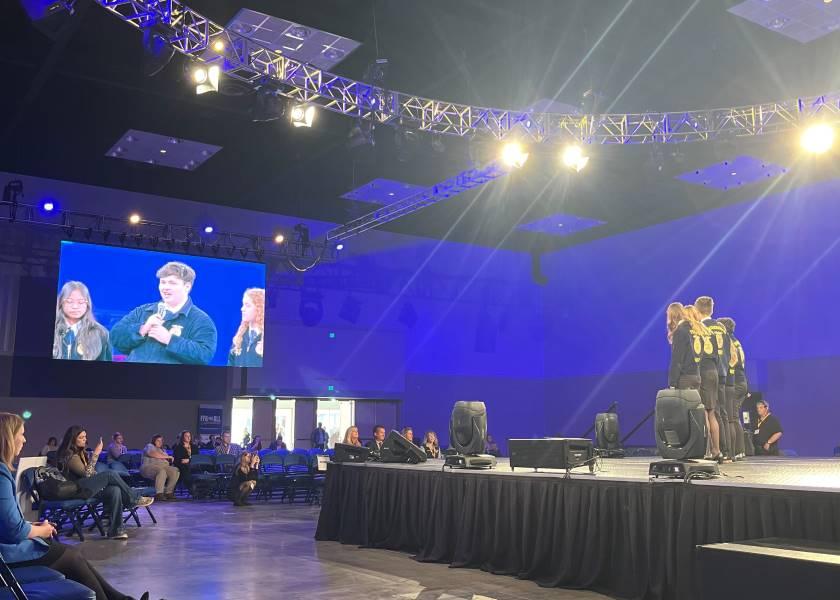 Bryson Boone of the Page FFA chapter in Georgia answers questions about his agriscience research project from a panel of industry professionals on the Student Showcase Stage at National FFA Convention.