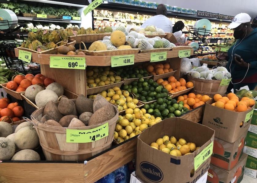 Shoppers inspect grocery store produce in 2022. Quince Supermarket is an independent grocer that can meet the needs of its niche market in and around Tamarac, Fla.