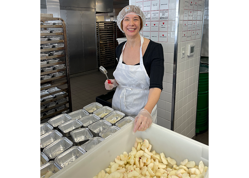 Amy Sowder, editor of PMG and retail education editor of The Packer, scoops New York-grown apples for French toast at God's Love We Deliver, which makes and delivers medically tailored meals to people with serious illness in New York City and surrounding areas.