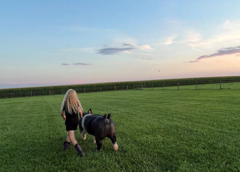 Harper taking her pig for a walk last summer. 