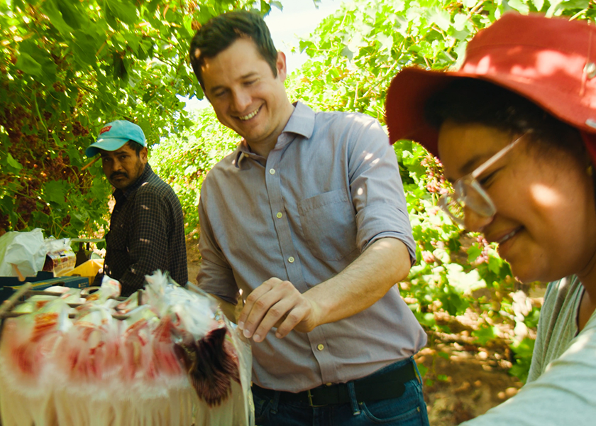 ProducePay founder Pablo Borquez Schwarzbeck is shown in a field with a grower.