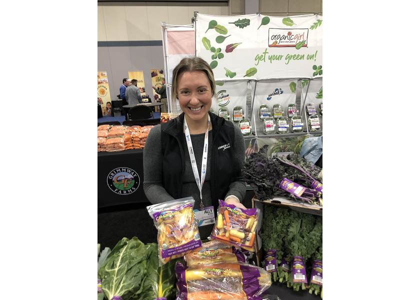 Ally Nesci, East Coast regional sales manager for Grimmway Farms, Bakersfield, Calif., displays the firm’s rainbow carrots March 22 at the 2023 AWG Innovation Showcase in Overland Park, Kan.