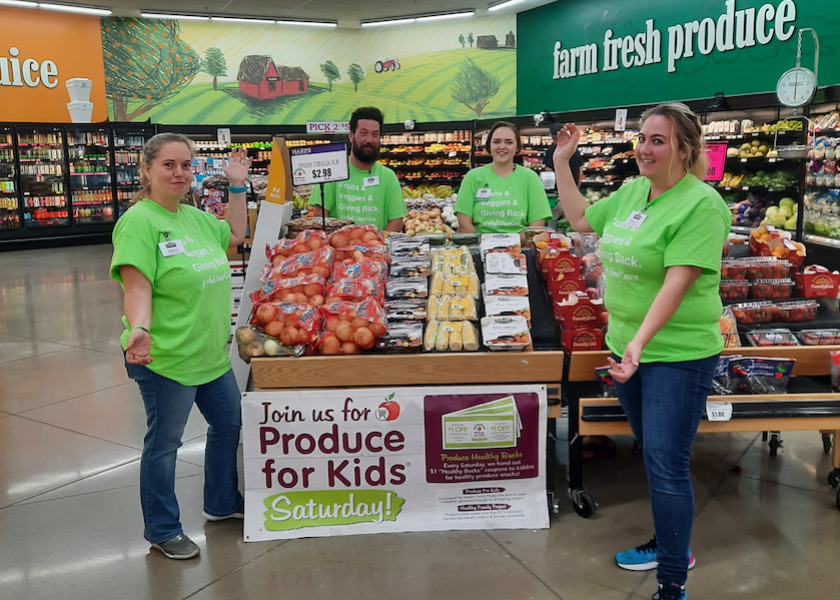 Employees at Harps Food Stores participate in the Produce for Kids program.
