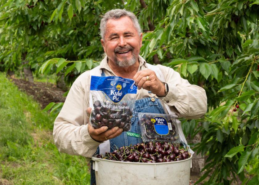 Stemilt cherry grower Kyle Mathison displays the marketer's new premium cherry label.