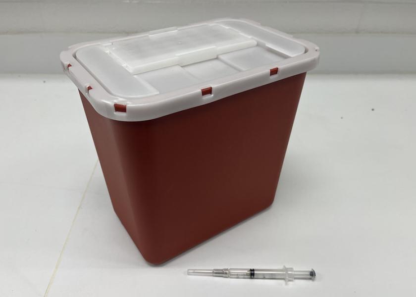 A sharps container safely stores medical waster.