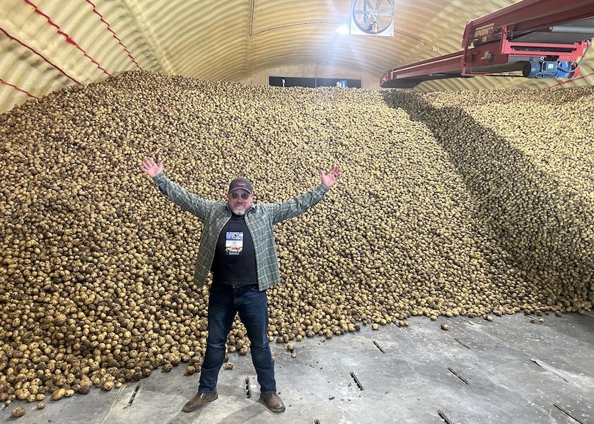 Eric Meisel of Gordon Food Service revels in the millions of potatoes in the shed at Wada Farms in Idaho Falls, Idaho. Meisel was part of a group of produce foodservice professionals on an Idaho Potato Commission harvest tour Sept. 25-27.