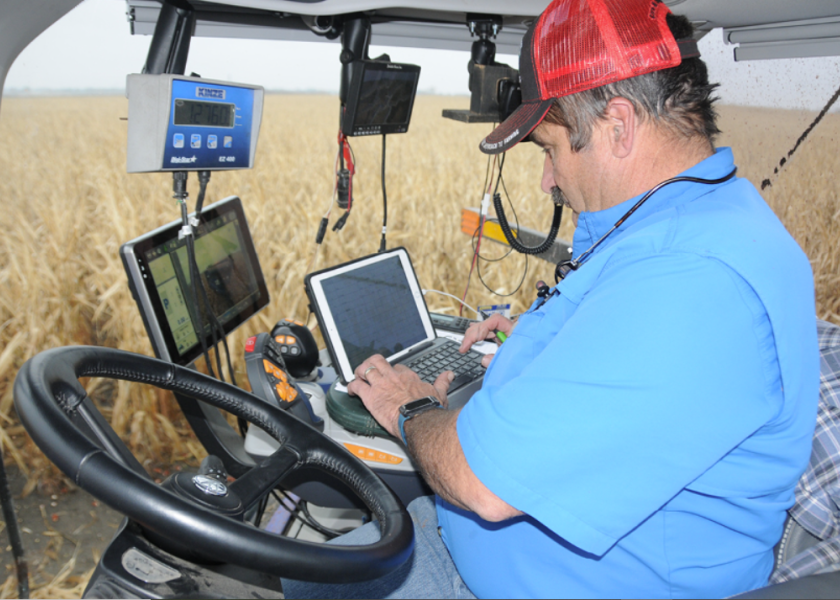 Ken Ferrie, Farm Journal Field Agronomist, collects information during corn harvest.