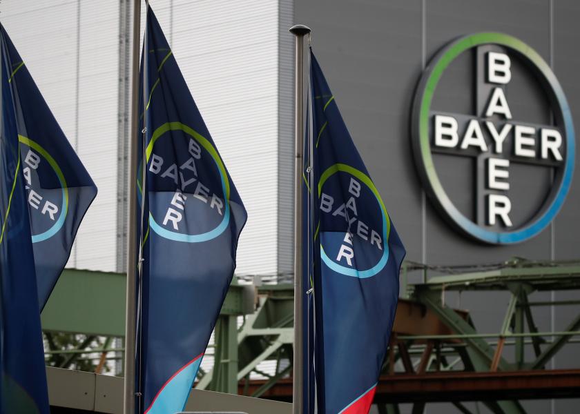 Logo and flags of Bayer AG pictured outside a plant of the German pharmaceutical and chemical maker in Wuppertal, Germany