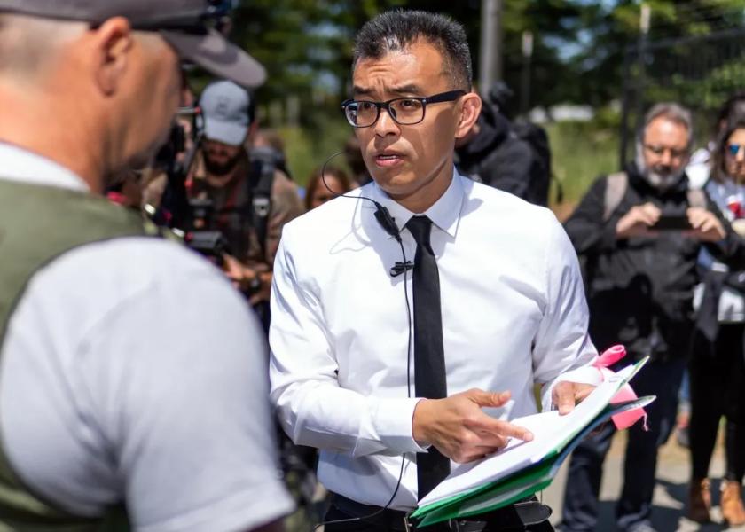 Wayne Hsiung speaks with an officer from the Sonoma County, California, Sheriff’s Office during an action at Reichardt Duck Farm in June 2019.