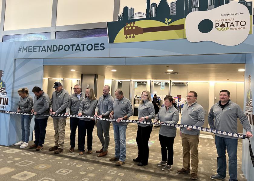 The National Potato Council's Potato Expo 2024 show floor opening kicked off with a ribbon cutting under #meetandpotatoes signage at the Austin Convention Center.