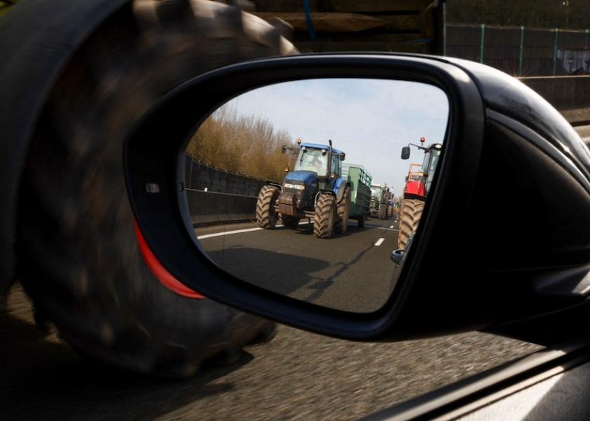 Tractors are reflected on a wing mirror as French farmers try to reach Paris during a protest over price pressures, taxes and green regulation, grievances shared by farmers across Europe, in Beauvais, France, Jan. 29, 2024.