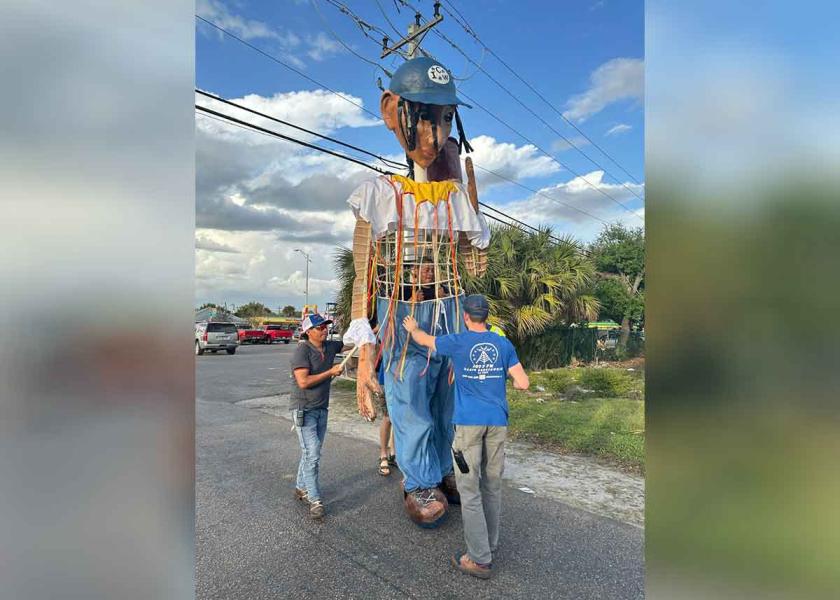 Organizers prepare two-story tall puppet of a woman farmworker for the Coalition of Immokalee Workers farmworker festival.
