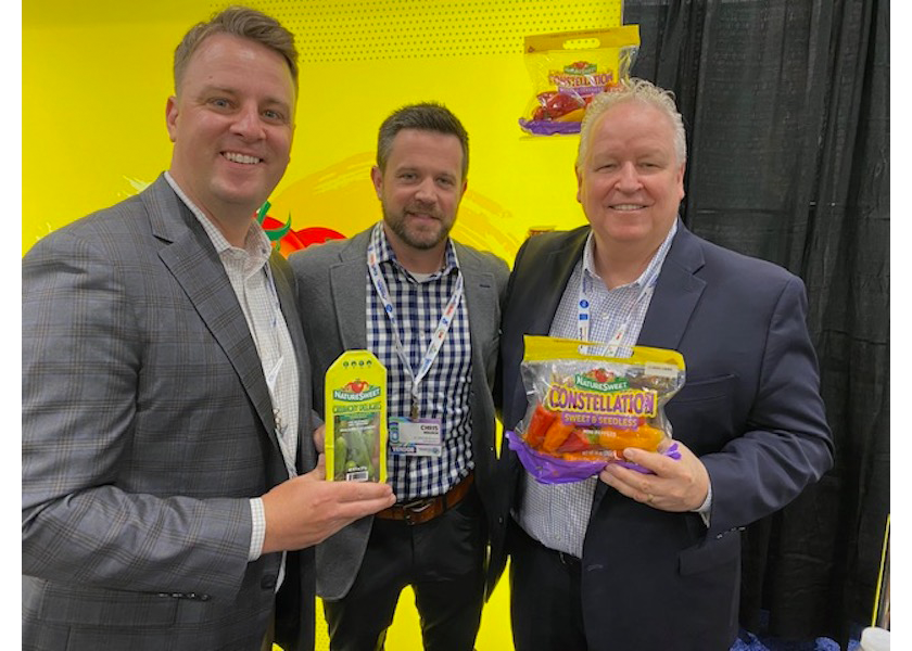 NatureSweet executives at the Associated Wholesale Grocers' seventh annual Innovation Showcase display the soon-to-arrive micro-cucumber pack and its Constellation brand of seedless mini sweet peppers. Shown from left are Steven Bindas, division sales manager; Chris Holden, director of sales for Northeast; and Jim McErlean, vice president of customer relations.