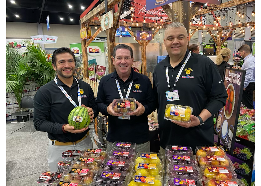 Pacific Trellis Fruit was highlighting its premium fruit offerings at the AWG Showcase. Shown from left are Juan Andino, senior sales executive for Pacific Trellis Fruit, Los Angeles, Calif., Howard Nager, director of marketing and business development; and Joe Barrett, sales executive.