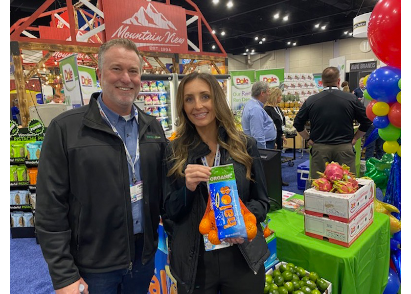 Larry Goens, vice president of sales for Wonderful Citrus, and Emily Parr, regional sales manager for the Plains, display Wonderful Organic Halos at the AWG Showcase on March 25.