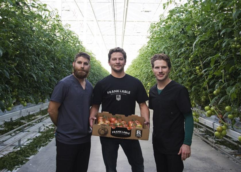 Keith Vis (from left), Devin Jasper and Dirk Vis with a box of Frank & Able tomatoes-on-the-vine in their Redcliff, Alberta greenhouse.  

