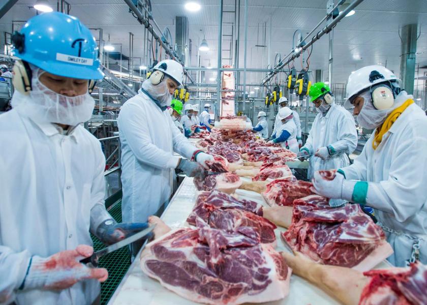 Workers at a pork processing facility
