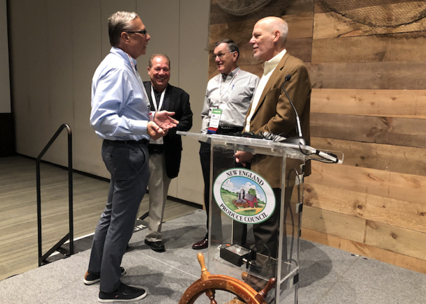 Industry professionals talk after a speaking event at the 2019 New England Produce Council Expo.