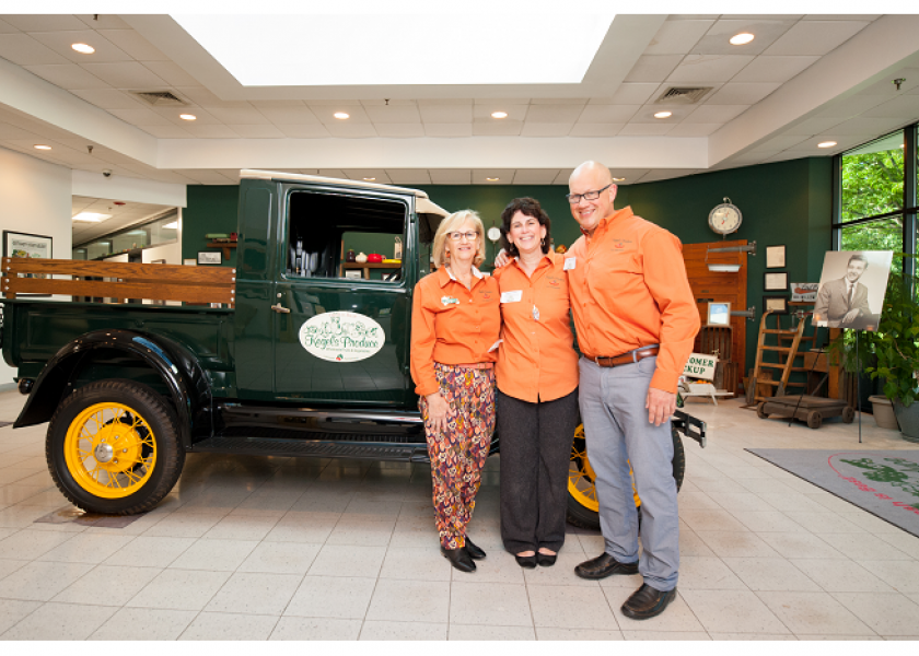 At an event celebrating Kegel's Produce's 70th anniversary, President Suzanne Myers (from left), Dawnne Monka, assistant to the chief operating officer, and Kenny Myers, chief operating officer, pose with a vintage truck.