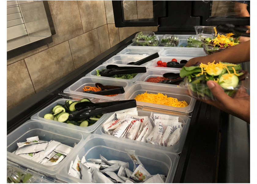 Students at Faith Family Academy-Oak Cliff enjoy from produce from a salad bar donated by the Dallas Fresh Food Association in May.
