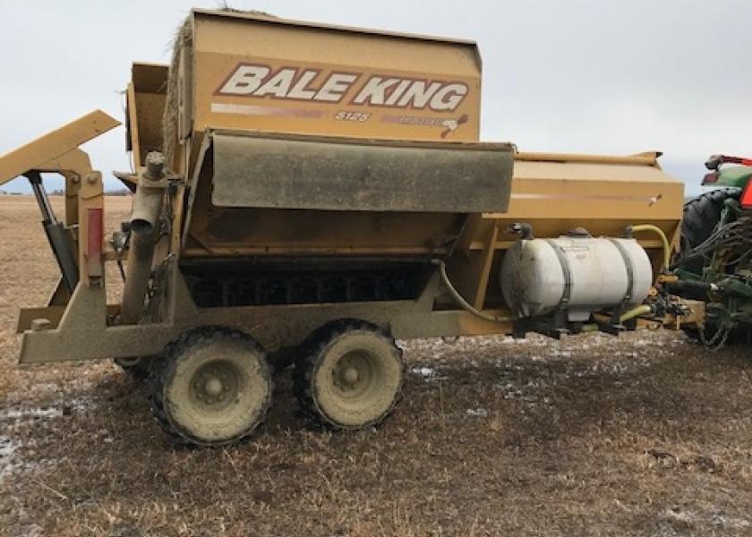 This bale processor, modified with a spray system for applying liquid supplement, allows a rancher to feed a measured dose of Rumensin to gestating cows.


