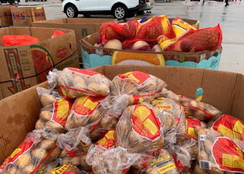 Produce shippers have been donating to excess produce to food banks as they wait for COVID-19 federal relief programs to begin. In the picture, potatoes and other produce are distributed at a Houston neighborhood.
