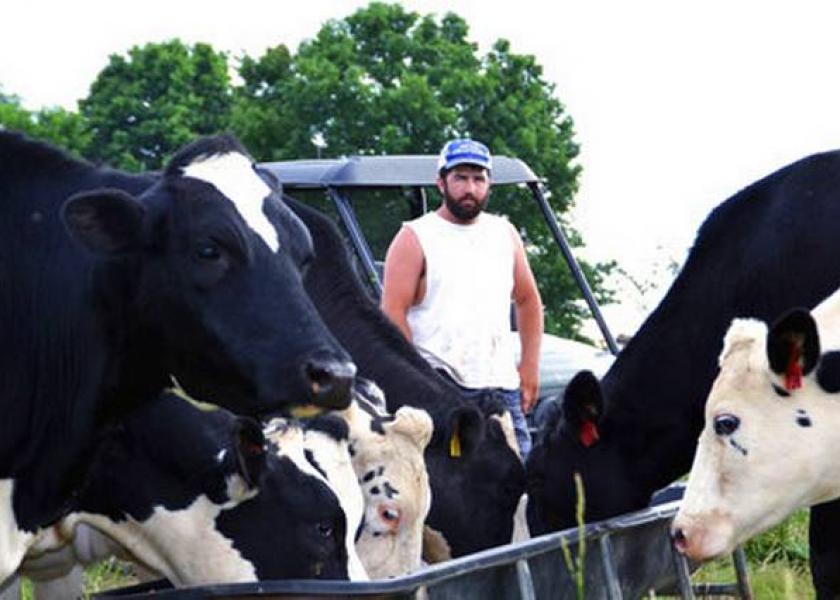 In this photo taken May 17, 2017, Ben Seaton, 21, stands on his family's dairy farm in Debusk, Tenn. Seaton takes pride in the cows he has bred and now milks each day on the farm.