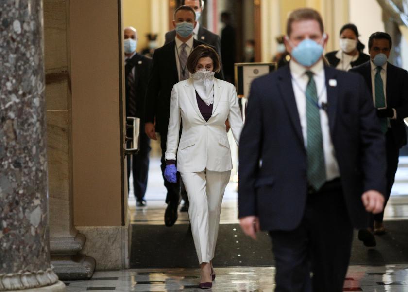 U.S. Speaker of the House Nancy Pelosi (D-CA) wears a face mask as she walks to the House Chamber ahead of a vote on an additional economic stimulus package passed earlier in the week by the U.S. Senate, on Capitol Hill in Washington, U.S., April 23, 2020. REUTERS/Tom Brenner