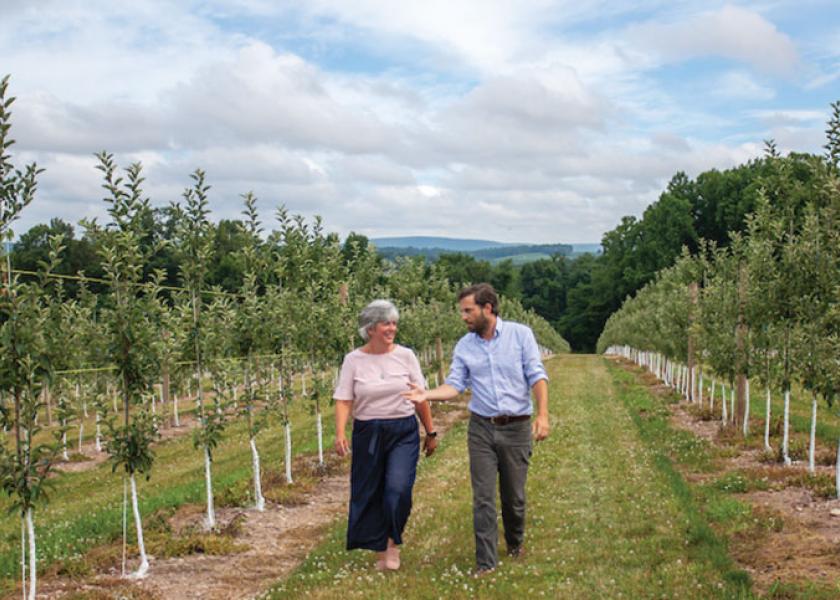 Brenda Briggs, vice president of sales and marketing for Rice Fruit Co., and Ben Rice, president, check on some of the company’s apple trees.