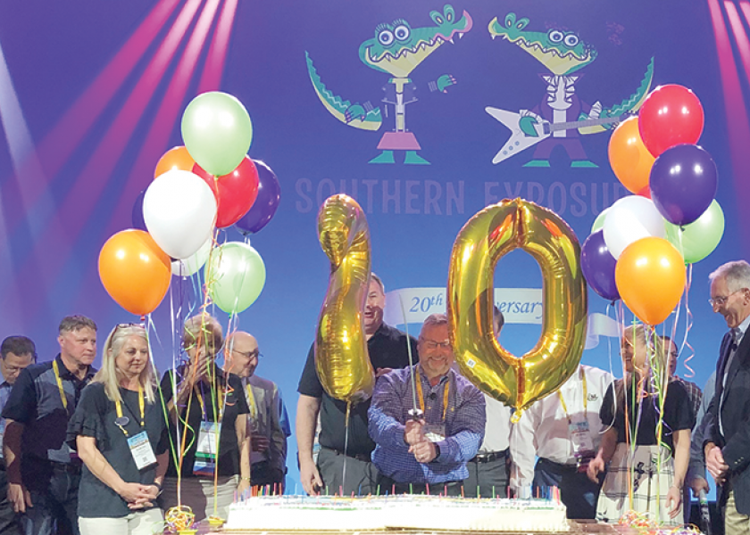 David Sherrod (center), president and CEO of the Southeast Produce Council, cuts a cake with a sword at last year’s Southern Exposure to celebrate the 20th anniversary of the show.