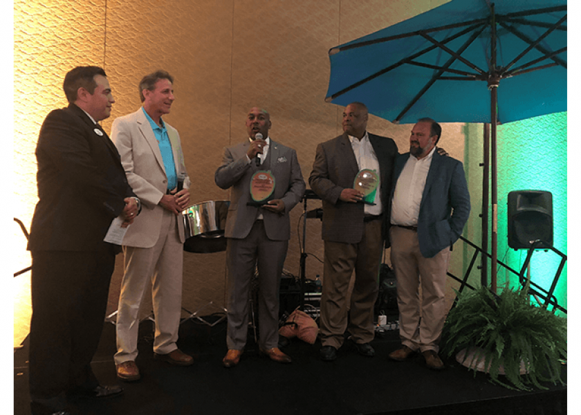 Perno W. Young III of ShopRite accepts the Mango Retailer of the Year award with his colleague Derrick S. Jenkins (second from right), who is standing with Lance Jungmeyer of the Fresh Produce Association of the Americas. The award was presented by Manuel Michel and Michael Warren of the National Mango Board. 