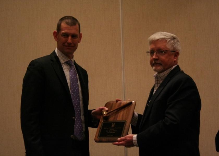 Dr. Brad White (left) passes the gavel to new AVC president K. Shawn Blood.